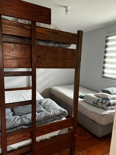 En eller flere senge i et værelse på COMODO Y AMPLIO DEPARTAMENTO, Temuco