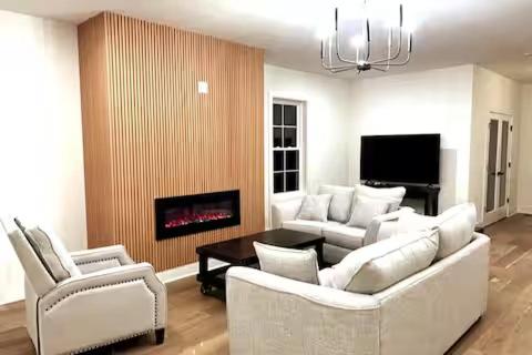 a living room with white furniture and a fireplace at 35 Room 1 - 1 King Bed, Private Bathroom - Nonsmoking in Arlington