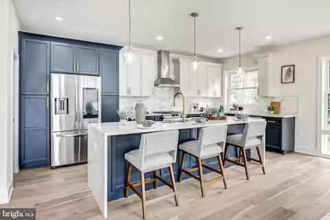 a kitchen with a large island with chairs in it at 35 Room 1 - 1 King Bed, Private Bathroom - Nonsmoking in Arlington