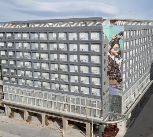 a building with a large mural on the side of it at Capsis Hotel Thessaloniki in Thessaloniki