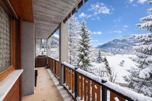 een balkon met uitzicht op de met sneeuw bedekte bergen bij Residence Dolonne - Happy Rentals in Courmayeur