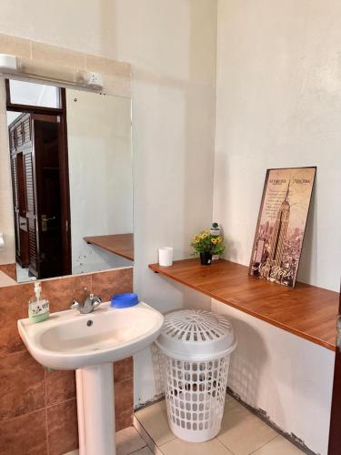a bathroom with a sink and a mirror at 3Bedroom Villa-Shanzu, Mombasa in Mombasa