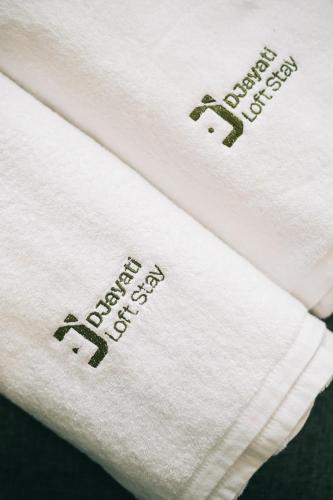 two white towels with the words happy birthday on them at Djayati Loft Stay in Yogyakarta