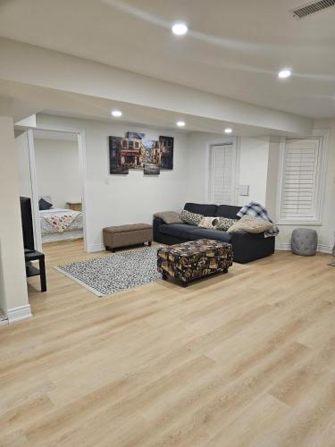 a living room with a couch and a table at 2 Bed, 1 Bath- Main floor, 2 Parking- Licensed in Oakville