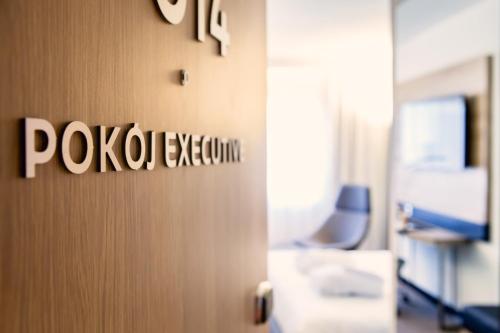 a room with a door with a sign on the wall at Novotel Wrocław Centrum in Wrocław