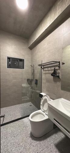 a bathroom with a toilet and a sink at 陌野輕旅民宿 in Xiulin