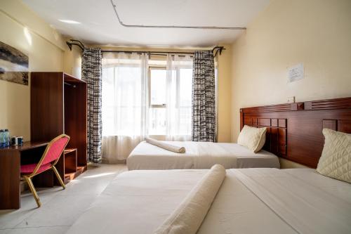 En eller flere senge i et værelse på Capital Comfort Hotel Ambala Road