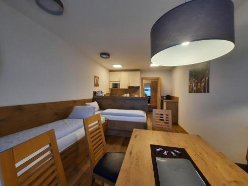 a small room with a bed and a dining table at Haus Roman Falch in Sankt Anton am Arlberg