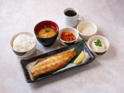 a tray of food with rice and fish and other foods at APA Hotel Higashi Shinjuku Ekimae in Tokyo