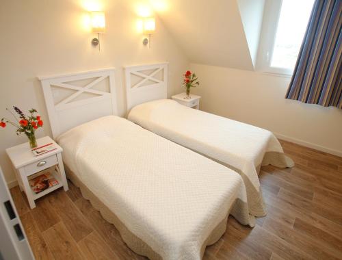 Postel nebo postele na pokoji v ubytování Résidence Odalys Les Villas de la Baie