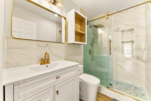 a bathroom with a sink and a glass shower at Lyn's Stay in Westminster