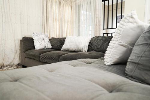 sala de estar con sofá y almohadas en Royal Palm, en Mokopane