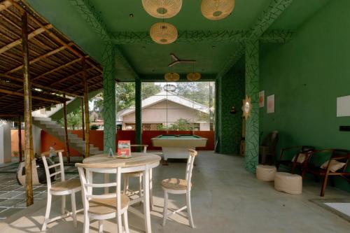 a room with a table and chairs and a pool table at Social Stays in Negombo