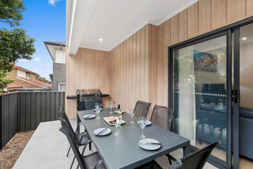 a dining room with a table and chairs at Saltwater Escape - Live the Sand and Surf Lifestyle in Wollongong