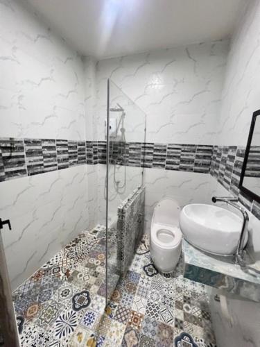 a bathroom with a shower and a toilet and a sink at Stingless Villa in Ban Ket Ho