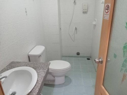 a bathroom with a toilet and a sink and a shower at Town View Hostel - Krabi Town in Krabi town