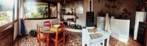 a dining room with a table and chairs in a house at Faly madatour GH in Antsirabe