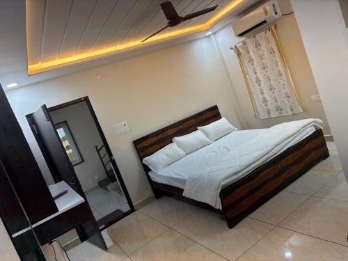 a bedroom with a bed and a mirror in it at V guesthouse staycation in Bāpatla