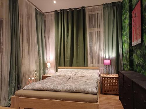 a bedroom with a bed and green curtains at Das Moritz- Self Check In in Plauen