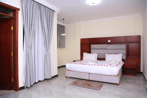 Ένα ή περισσότερα κρεβάτια σε δωμάτιο στο Yemata Hotel