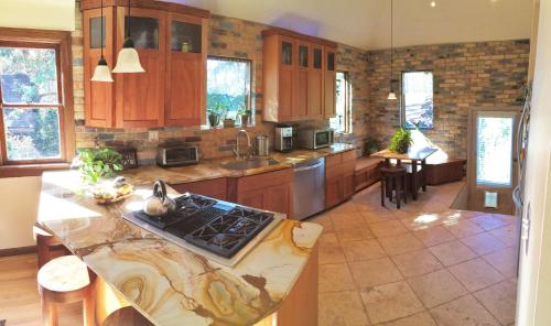 a kitchen with wooden cabinets and a counter top at 6-Bedroom Tudor in the Downtown Historic District in Salt Lake City