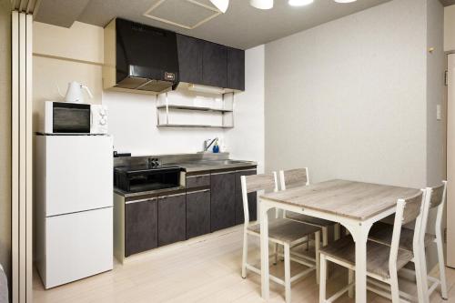 a kitchen and dining room with a table and chairs at Make Your Hotel Susukino E in Sapporo