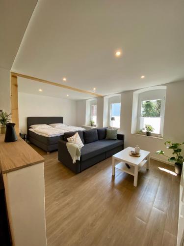a living room with a couch and a bed at Fewo Catlen in Traben-Trarbach