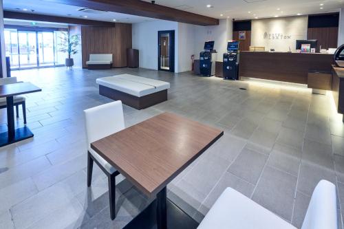 a lobby with a table and chairs in a building at Hotel Lexton Kagoshima Annex in Kagoshima