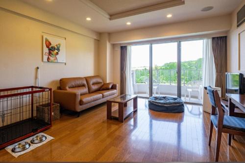 a living room with a couch and a table at Scenery Resort Suruga in Numazu