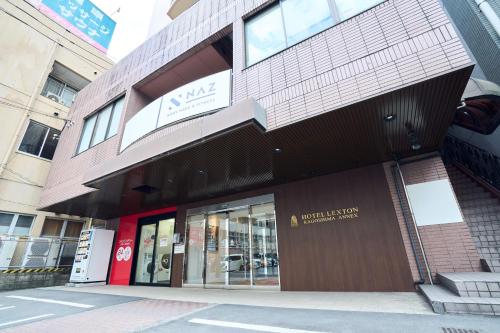 a building with a sign on the side of it at Hotel Lexton Kagoshima Annex in Kagoshima
