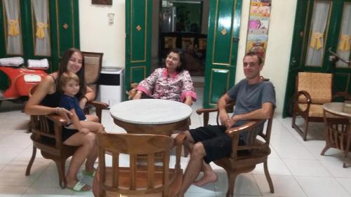 a group of people sitting around a table at Pendopo Andari Homestay in Yogyakarta