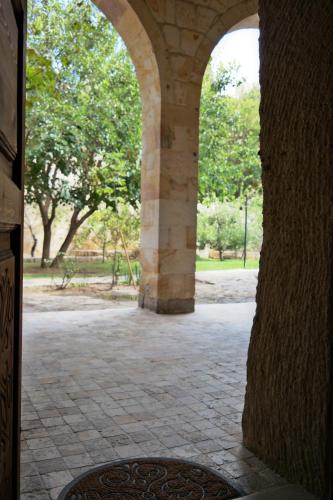 an archway in a building with trees in the background at Dreams Cave Hotel in Ortahisar