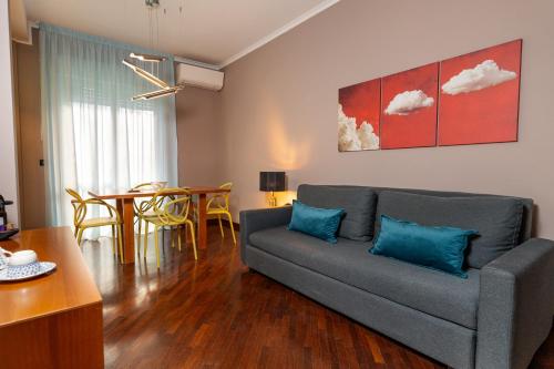a living room with a couch and a table at Apulia Re' Aparthotel & Suites in Bari