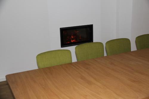 a conference room with a table and a fireplace at Forsthaus in Katzwinkel in Katzwinkel