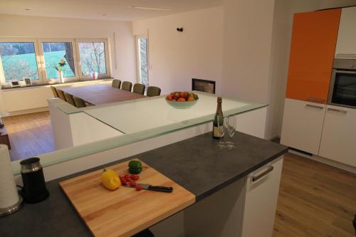 a kitchen with a table with a bottle of wine at Forsthaus in Katzwinkel in Katzwinkel