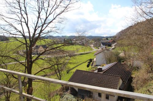 a view of a green field and a house at Forsthaus in Katzwinkel in Katzwinkel