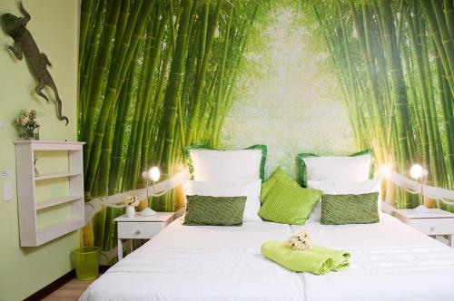 a bedroom with a bed with a green wall at a Vue Guesthouse in Somerset West