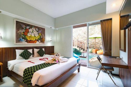 Postel nebo postele na pokoji v ubytování Hadi Poetra Hotel