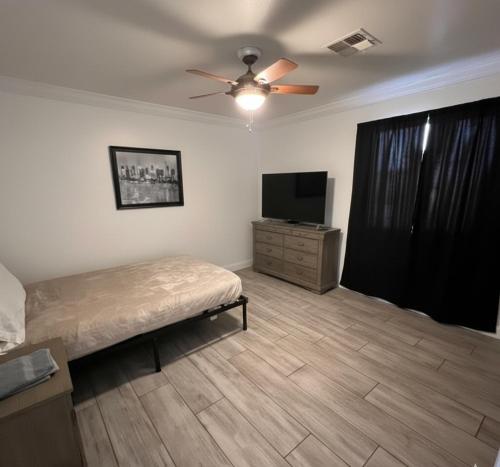 a bedroom with a bed and a flat screen tv at Downtown Secluded Room 3 in Phoenix