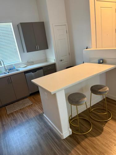 a kitchen with a counter and two stools at 3 bedroom private villa in Phoenix