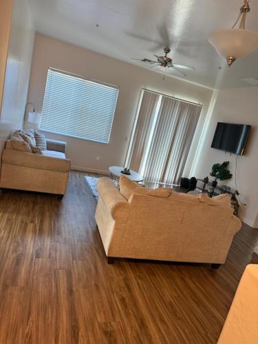 a living room with two couches and a tv at 3 bedroom private villa in Phoenix