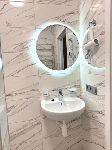 a bathroom with a sink and a mirror at Polyana Park House aparts in Polyana