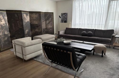 a living room with a couch and a table at Near Amsterdam and airport, 90m2, privacy! in Hoofddorp