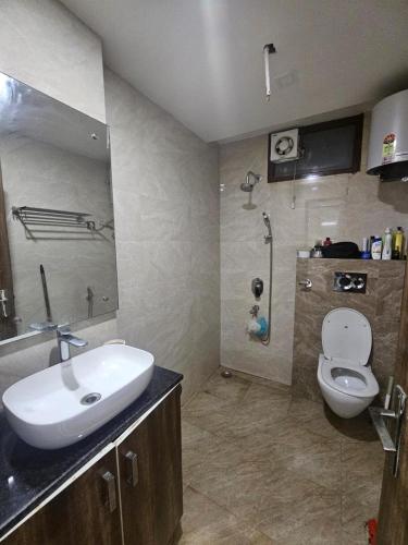 a bathroom with a sink and a toilet at Independent Floor in Gurgaon