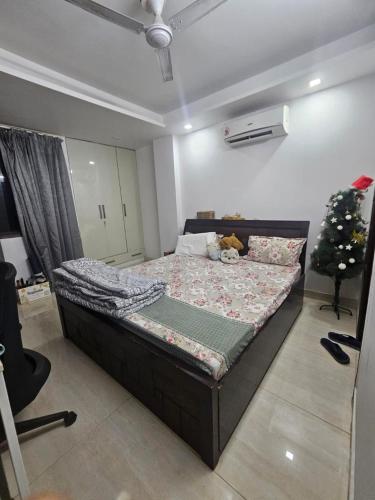 a bedroom with a bed with a christmas tree on it at Independent Floor in Gurgaon