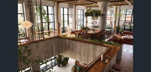 a large room with tables and chairs and windows at Luxury Apartment with Stunning Southbank Views in Melbourne