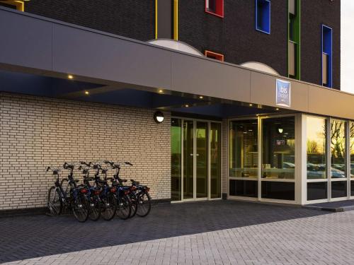 a group of bikes parked outside of a building at ibis budget Rotterdam The Hague Airport in Rotterdam