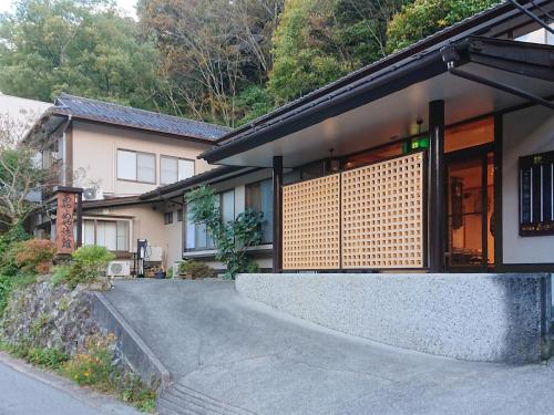a house with a ramp leading up to a building at Ayameya Ryokan in Nakanojo