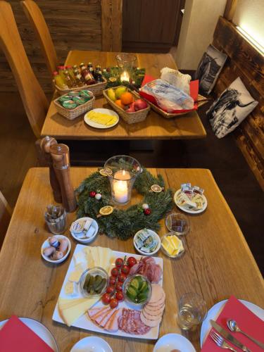 a table with fruits and vegetables and a candle on it at Alpenglühn Apartments - Adult Only ab Februar 2026 in Berchtesgaden