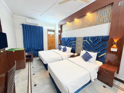 a hotel room with two beds and a tv at Royal Continental in Islamabad